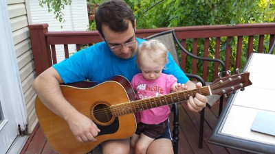 Loves playing guitar with Daddy.